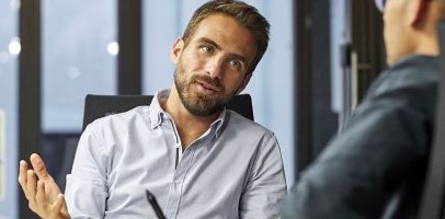 2 mannen die met elkaar in gesprek zijn op een kantoor
